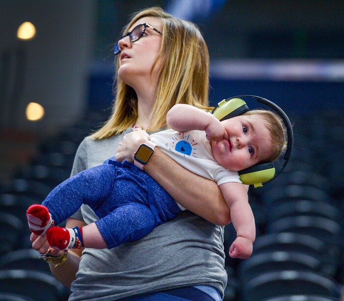 Leah Hogsten  |  The Salt Lake Tribune  Ali Segebrecht holds her 6-month-old son Hughes during Kansas Jayhawks practice at the 2019 NCAA Division I Men's Basketball Championship, March 20, 2019 in preparation for their first round game against the Northeastern Huskies on Thursday. Segebrecht is a Kansas alumni and moved from Lawrence to Salt Lake City a year ago. 