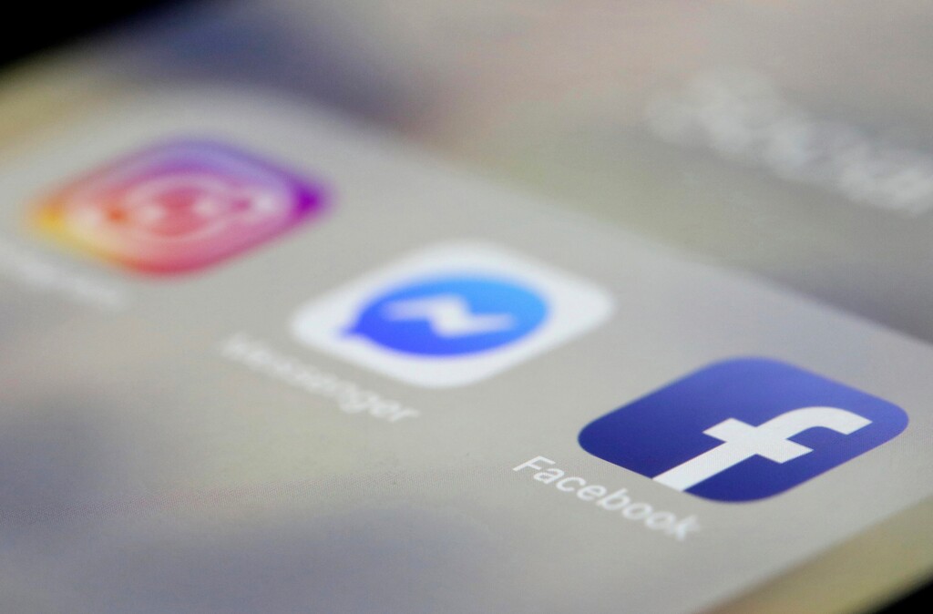 (Jenny Kane | The Associated Press) In this March 13, 2019, file photo Facebook, Messenger and Instagram apps are are displayed on an iPhone in New York. Facebook said Wednesday, March 27, that it is broadening its definition of hate speech to apply to "white nationalists" and "white separatists." The company previously allowed posts from those groups even though it has long banned "white supremacists."