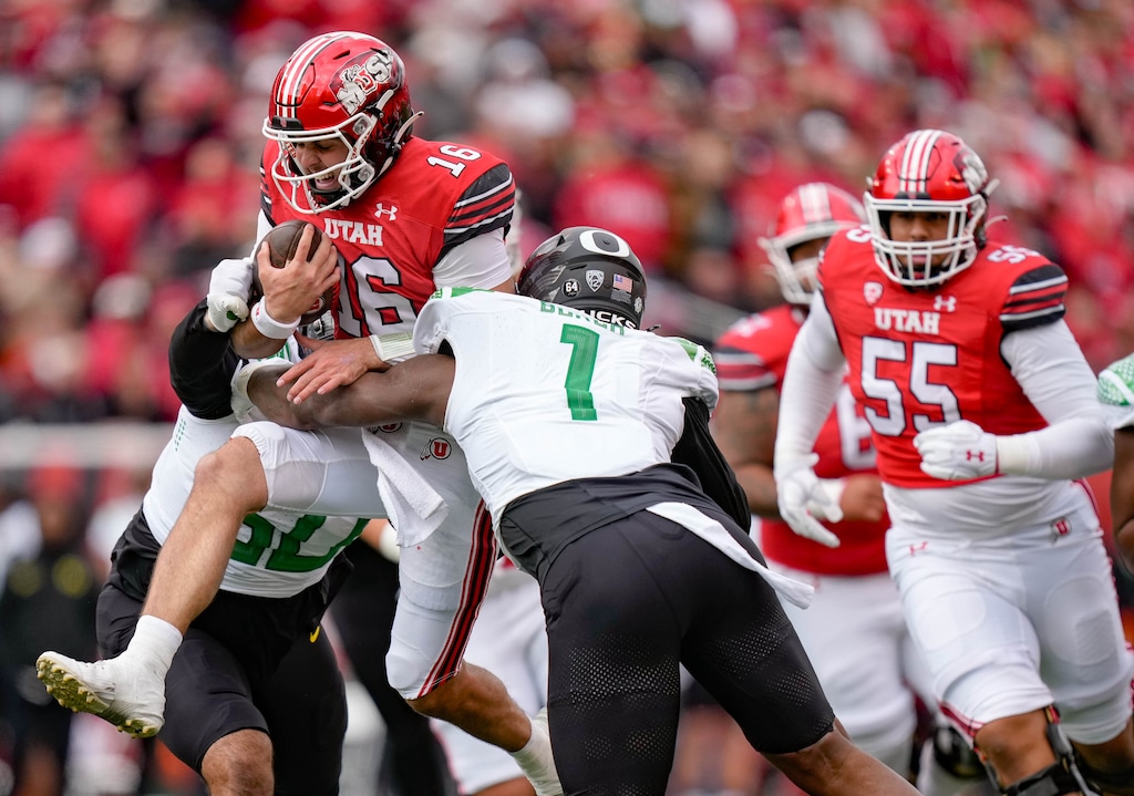 (Francisco Kjolseth  |  The Salt Lake Tribune) Utah Utes quarterback Bryson Barnes (16) is stopped by Ducks defensive end Jordan Burch (1) as the Utah Utes host the Oregon Ducks, NCAA football in Salt Lake City on Saturday, Oct. 28, 2023, with a blistering loss falling 35-6.