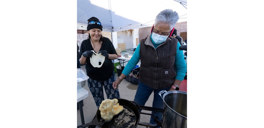 (Rick Egan | The Salt Lake Tribune) A woman named 505 and Eloise Shiimaa make Navajo Tacos, during a "Gratitude Dinner" served by volunteers from the group Black Lives for Humanity, on 500 West in Salt Lake City, on Thursday, Nov. 25, 2021. The group served   to more than 100 people from the unsheltered population, with donations from the community.