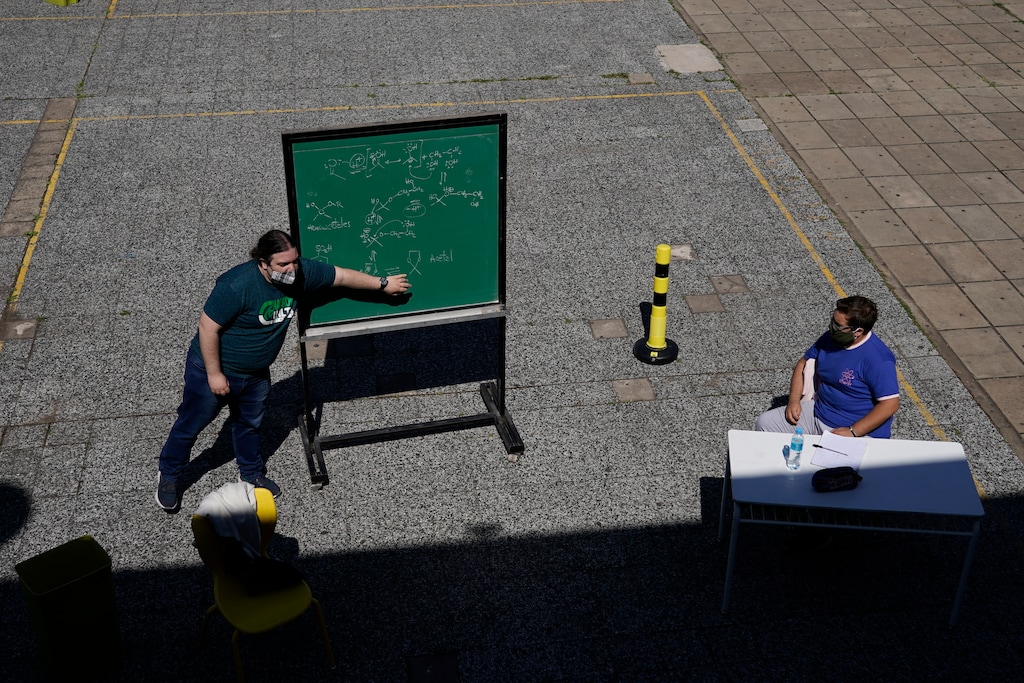 (Victor R. Caivano | AP photo)

In this Oct. 13 photo, a teacher leads a lesson outdoors at the school Hipólito Yrigoyen in Buenos Aires, Argentina, on the first day since the COVID-19 pandemic outbreak that in-person classes in the capital for students in their last year of primary and secondary school were restarted, but outdoors. Argentina reached 1 million confirmed coronavirus cases on Monday, Oct. 19, 2020, according to the Ministry of Health.