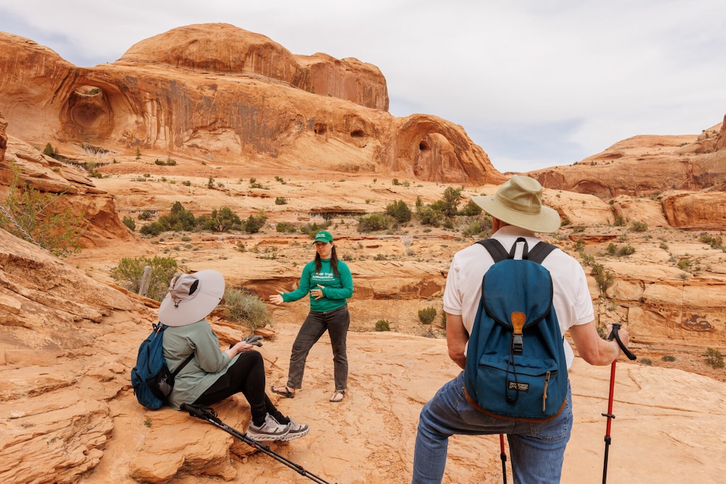 (Corie Spruill) Moab Trail Ambassador Program Coordinator Anna Sprout speaks with visitors on the Corona Arch trail. Photos courtesy of Grand County Active Transportation and Trails.