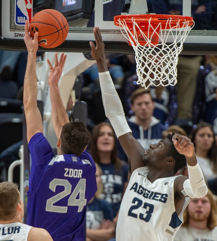 (Rick Egan  |  The Salt Lake Tribune)   Weber State Wildcats forward Dima Zdor (24) shoots asUtah State Aggies center Neemias Queta (23), in the Beehive Classic, between against the Utah State Aggies and Weber State Wildcats, a the Vivint Smart Home Arena, Saturday December 8, 2018.

 