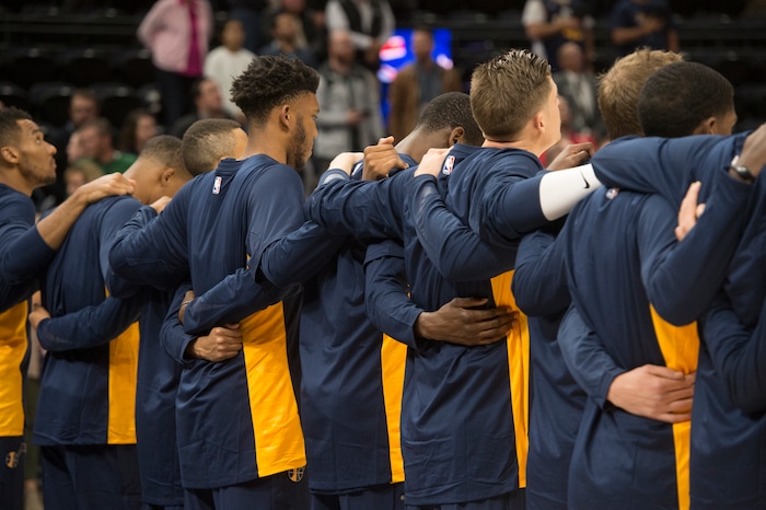 (Rick Egan  |  The Salt Lake Tribune) The Utah Jazz stand together arm in arm, during the national anthem, in preseason basketball  action, Utah Jazz vs. Sydney Kings, in Salt Lake City, Sunday, October 2, 2017.


