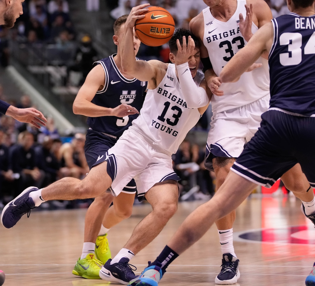 (Francisco Kjolseth | The Salt Lake Tribune) Brigham Young Cougars guard Alex Barcello (13) collides with teammate Brigham Young Cougars forward Caleb Lohner (33) as he tries to pivot in basketball action between the Brigham Young Cougars and the Utah State Aggies at the Marriott Center in Provo, Wednesday, Dec. 8, 2021.