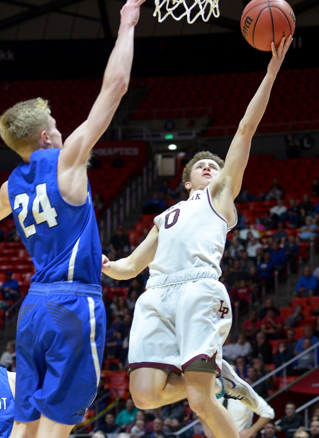 (Leah Hogsten  |  The Salt Lake Tribune) Lone Peak's Chantry Ross (00) slips past Pleasant Grove's Kael Mikkelsen (24). Lone Peak defeated Pleasant Grove 61-44 to win the 6A High School Boys’ Basketball Tournament Championship at the Jon M. Huntsman Center in Salt Lake City, Saturday, March 3, 2018. 