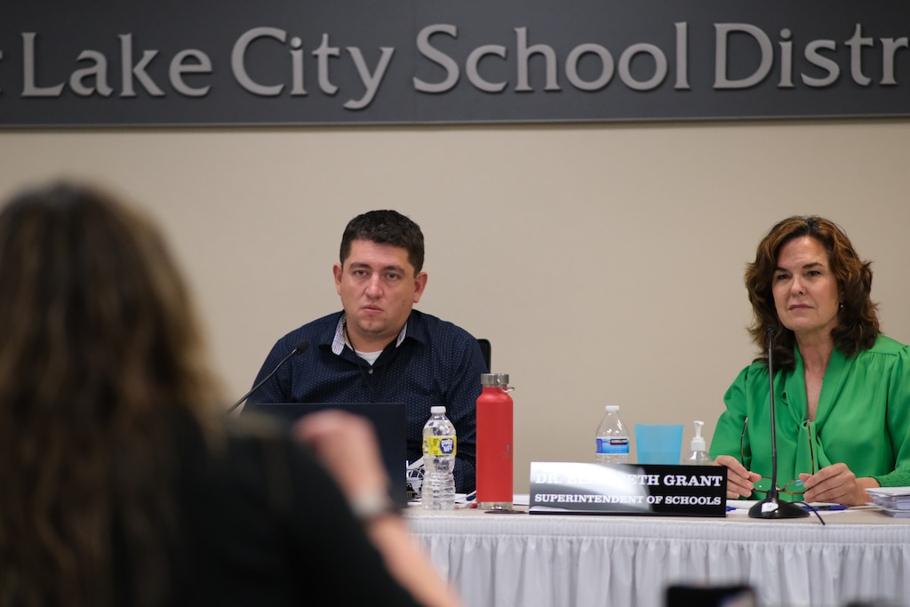 (Michael Lee | The Salt Lake Tribune) Salt Lake City school board vice president Bryce Williams and Superintendent Elizabeth Grant listen to Emerson parent Joey McNamee speak during public comment at a board meeting on Aug. 1, 2023.