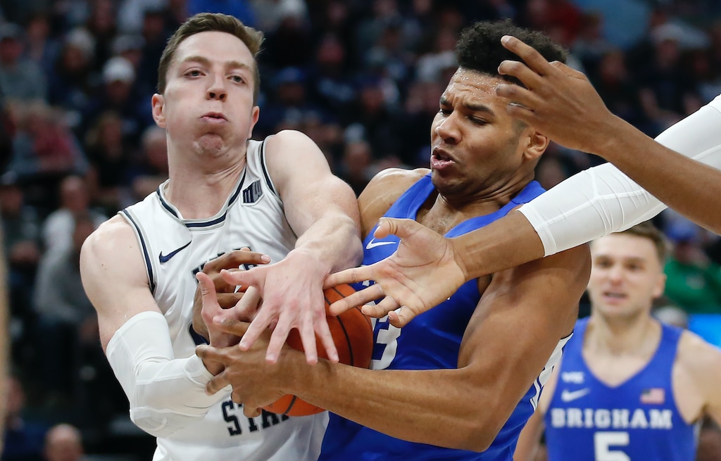 Utah State forward Justin Bean, left, and BYU forward Yoeli Childs, right, battle for a rebound in the second half during an NCAA college basketball game Saturday, Dec. 14, 2019, in Salt Lake City. (AP Photo/Rick Bowmer)