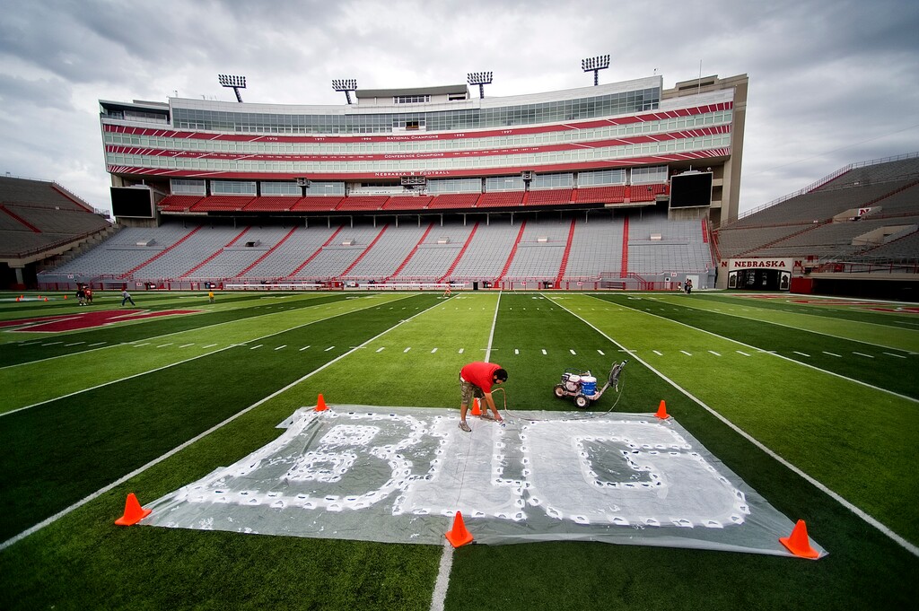 (Jacob Hannah | Lincoln Journal Star via AP file photo)  In this Thursday, Oct. 6, 2011, photo, Turf manager Jared Hertzel touches up the newly-painted Big Ten conference logo on the football field at Memorial Stadium in Lincoln, Neb.