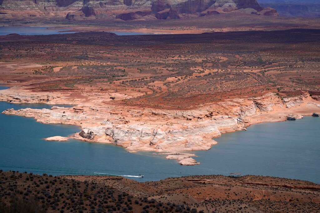 (Ross D. Franklin | Associated Press) A boat moves along Wahweap Bay along the Upper Colorado River Basin, June 9, 2021, at the Utah and Arizona border near Wahweap, Ariz. The Biden administration announced Thursday, Feb. 2, 2023, that 15 Native American tribes will get a total of $580 million in federal money this year for water rights settlements.