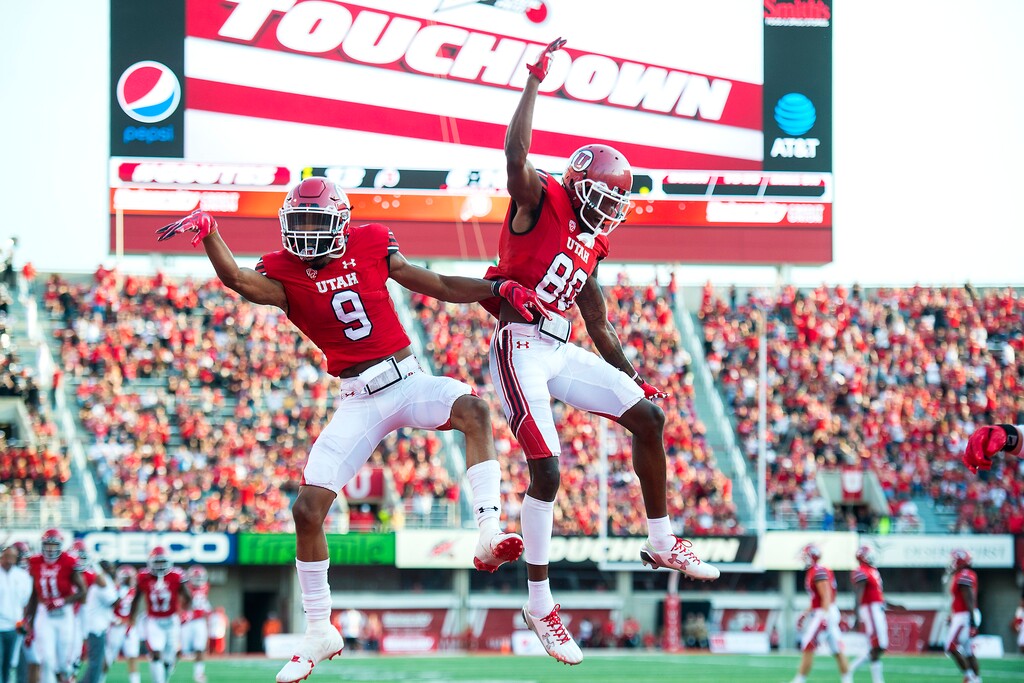 (Chris Detrick | The Salt Lake Tribune) Utah Utes wide receiver Darren Carrington (9) celebrates his touchdown with Utah Utes wide receiver Siaosi Wilson (80) during the game at Rice-Eccles Stadium Thursday, August 31, 2017. Utah Utes are leading North Dakota Fighting Hawks 17-9 at halftime.
