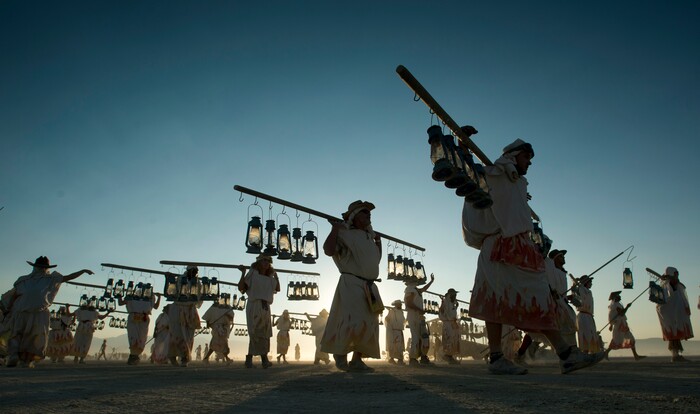 (Rick Egan  |  The Salt Lake Tribune)  The The Burning Man lamplighters make their way up the Promenade, as they hang the lights, during their nightly ritual. Saturday, September 2, 2017.