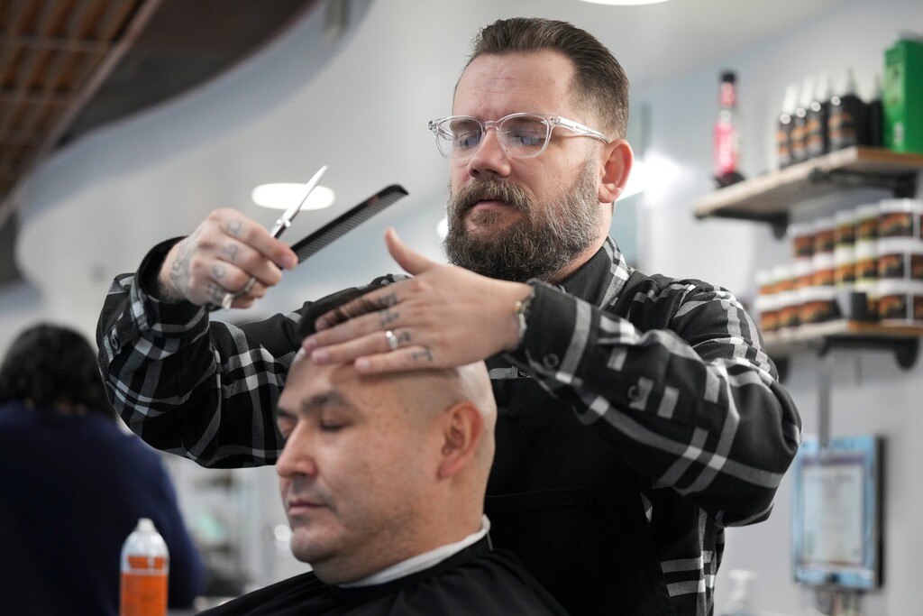 (Bethany Baker | The Salt Lake Tribune) Dave Broderick cuts Nick Cardon's hair at The Bureau Barber and Shop in Salt Lake City on Tuesday, March 18, 2025.