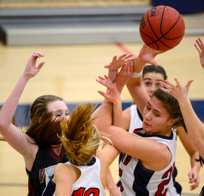(Trent Nelson  |  The Salt Lake Tribune)  Players reach for a rebound as Woods Cross hosts Viewpoint High School girls basketball, Wednesday, January 24, 2018.