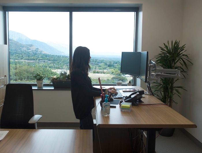 (Rick Egan  |  The Salt Lake Tribune)  Kimberly Mecham works on one of the workstations can adjust to standing at BioFire Diagnostic at Research Park. BioFire Diagnostic is one of the top performing companies in the Top Workplaces competition,Thursday, September 28, 2017.