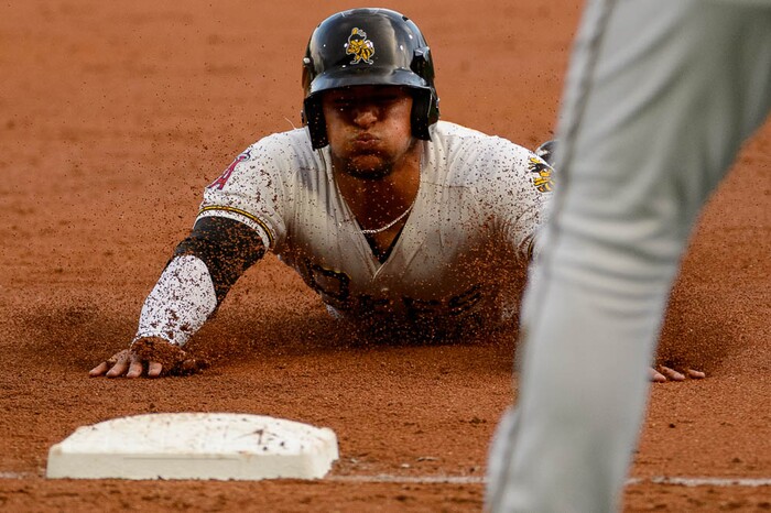 (Trent Nelson | The Salt Lake Tribune)  Salt Lake Bees vs. Albuquerque Isotopes, Triple-A baseball in Salt Lake City, Thursday April 5, 2018. Salt Lake's Jose Briceno (10) dives into third in the second inning.