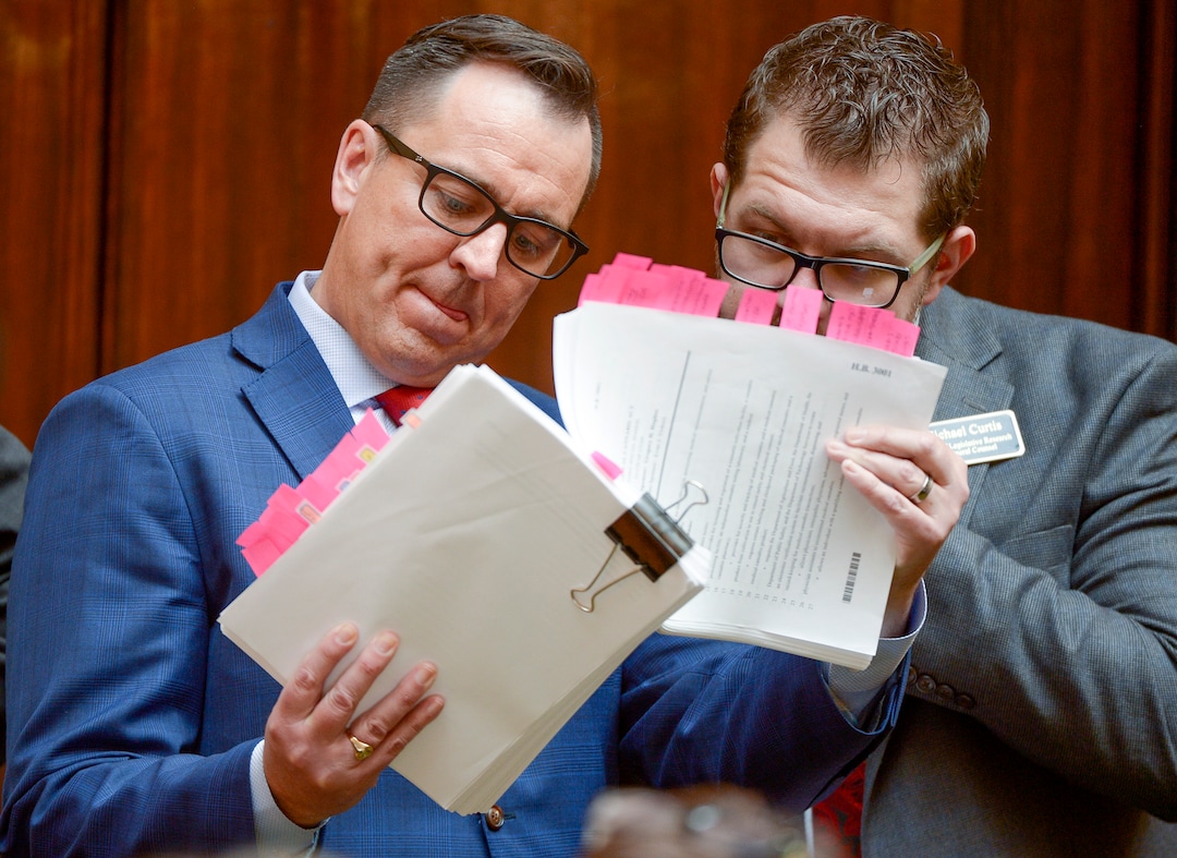 (Leah Hogsten  |  The Salt Lake Tribune)  L-r  House Speaker Greg Hughes, R-Draper thumbs through his proposed legislation with Michael Curtis, with the Office of Legislative Research and General Counsel while answering questions about his bill for House members.  Utah legislators voted to change the Utah Medical Cannabis Act, the bill that officials, Prop 2 opponents and medical marijuana advocates crafted and pitched as a compromise, Monday, Dec. 2, 2018 during a special session. Lawmakers voted for an overwritten version of the ballot initiative.