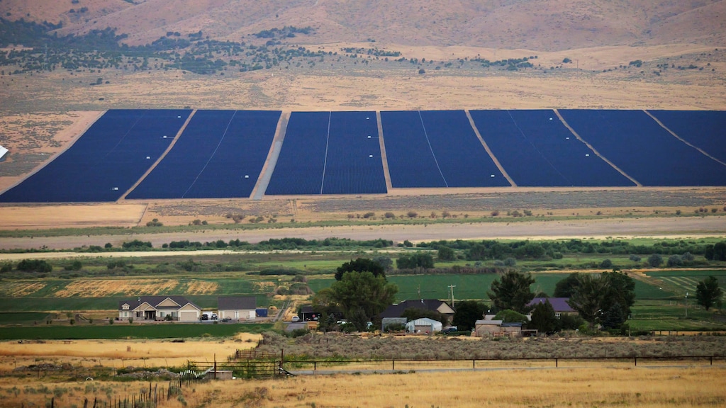 (Rick Bowmer | AP) A solar farm sits behind homes on Tuesday, Aug. 9, 2022, in the small town of Mona.