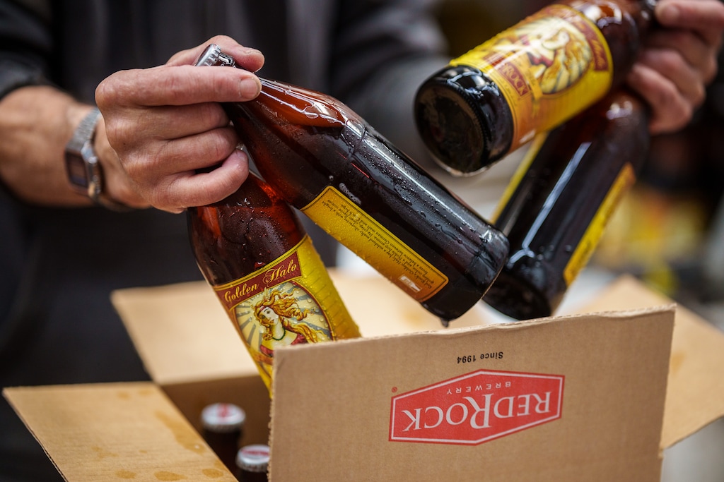 (Trent Nelson | The Salt Lake Tribune) A worker packages bottles of the Golden Halo Blonde Ale at Red Rock Brewery in Salt Lake City on Wednesday, Feb. 1, 2023. The ale is 5.8% ABV, which means Red Rock can't serve it on tap in Utah, and must serve it in bottles or cans.