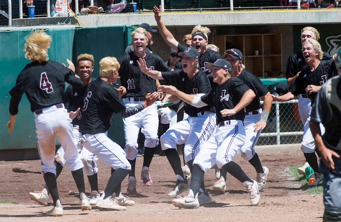 (Rick Egan  |  The Salt Lake Tribune)   Jordan High celebrates their 11-1 win over Olympus, for the 5A state baseball championship, at UVU in Orem, Friday, May 25, 2018.