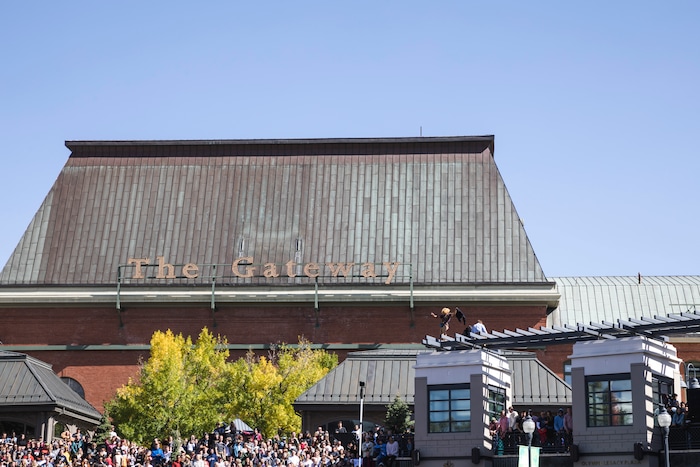 (Clark Clifford  |  Special to The Salt Lake Tribune) People crammed into Olympic Plaza even climbing on to the roof to get a better view at Kanye West's Sunday Service at The Gateway in Salt Lake City on Saturday, Oct. 5, 2019.