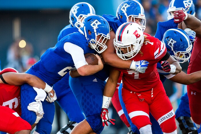 (Chris Detrick  |  The Salt Lake Tribune)  East's Johnson Hansen (6) tackles Bingham's Ryan Wood (2) during the game at Bingham High School Friday, August 25, 2017. Bingham is winning the game 24-17 at halftime. 