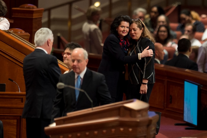 (Jeremy Harmon  |  The Salt Lake Tribune)  Wendy L. Watson embraces Susan Gong at the start of the Sunday afternoon session of General Conference on April 1, 2018.