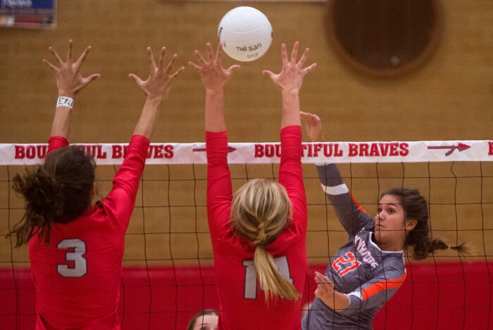 (Rick Egan  |  The Salt Lake Tribune)  Naomi Pulu (27), Skyridge, hits the ball past Hannah Howard (3), and Bri Mortensen, 14, Bountiful, in volleyball action, Bountiful vs. Skyridge, at Bountiful High, Wednesday, September 6, 2017.