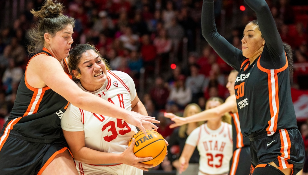 (Rick Egan | The Salt Lake Tribune)  Utah Utes forward Alissa Pili (35) takes the ball to the hoop as Oregon State Beavers forward Raegan Beers (15) and Oregon State Beavers forward Timea Gardiner (30) defend, in PAC-12 basketball action between the Utah Utes and the Oregon State Beavers, at the Jon M. Huntsman Center, on Friday, Feb. 9, 2024.