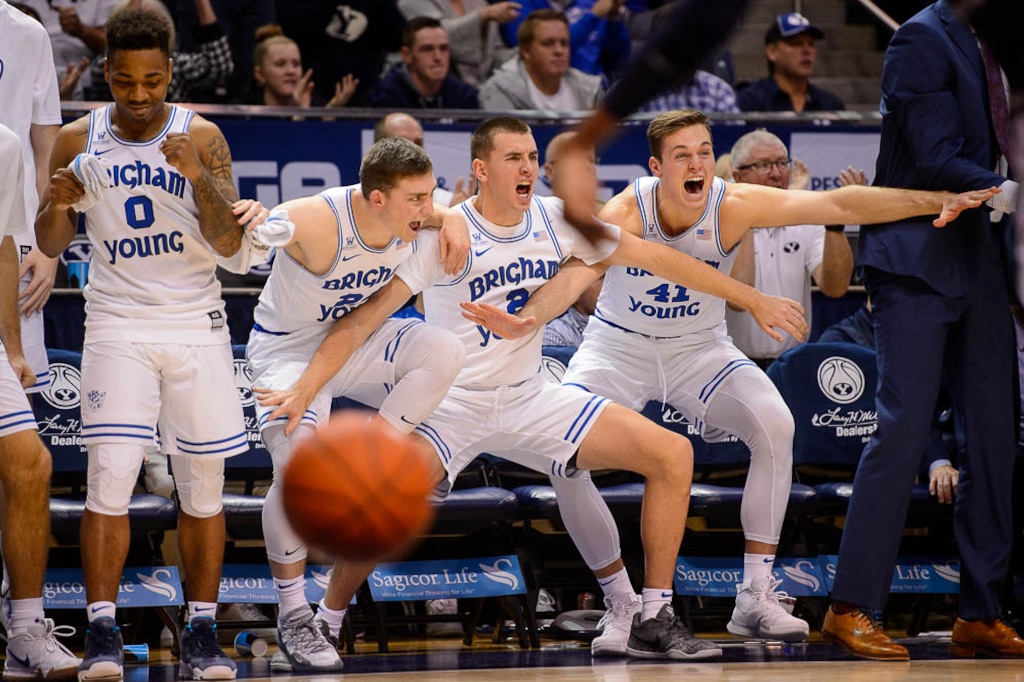 (Trent Nelson | The Salt Lake Tribune)  
BYU's men's basketball team celebrates from the bench as the Cougars complete a 95-80 rout of Utah State on Dec. 5, 2018 in the Marriott Center.