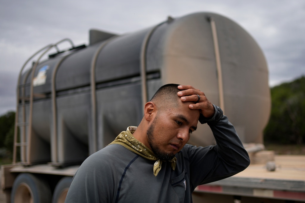 (John Locher | AP Photo)  Garnett Querta wipes sweat from his head while hauling water on the Hualapai reservation Monday, Aug. 15, 2022, near Peach Springs, Ariz. The water pulled from the ground here will be piped dozens of miles across the rugged landscape to serve the roughly 600,000 tourists a year who visit the Grand Canyon on the Hualapai reservation in northwestern Arizona Ñ an operation that's the tribe's main source of revenue.