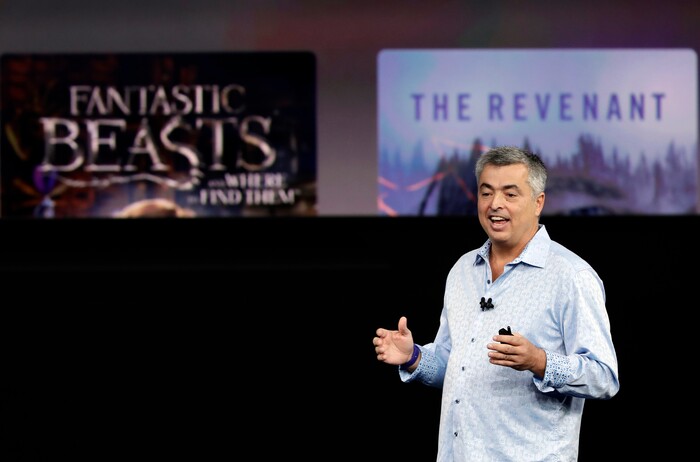 Eddy Cue, Apple's senior vice president of internet software, shows the new Apple TV product at the Steve Jobs Theater on the new Apple campus on Tuesday, Sept. 12, 2017, in Cupertino, Calif. (AP Photo/Marcio Jose Sanchez)