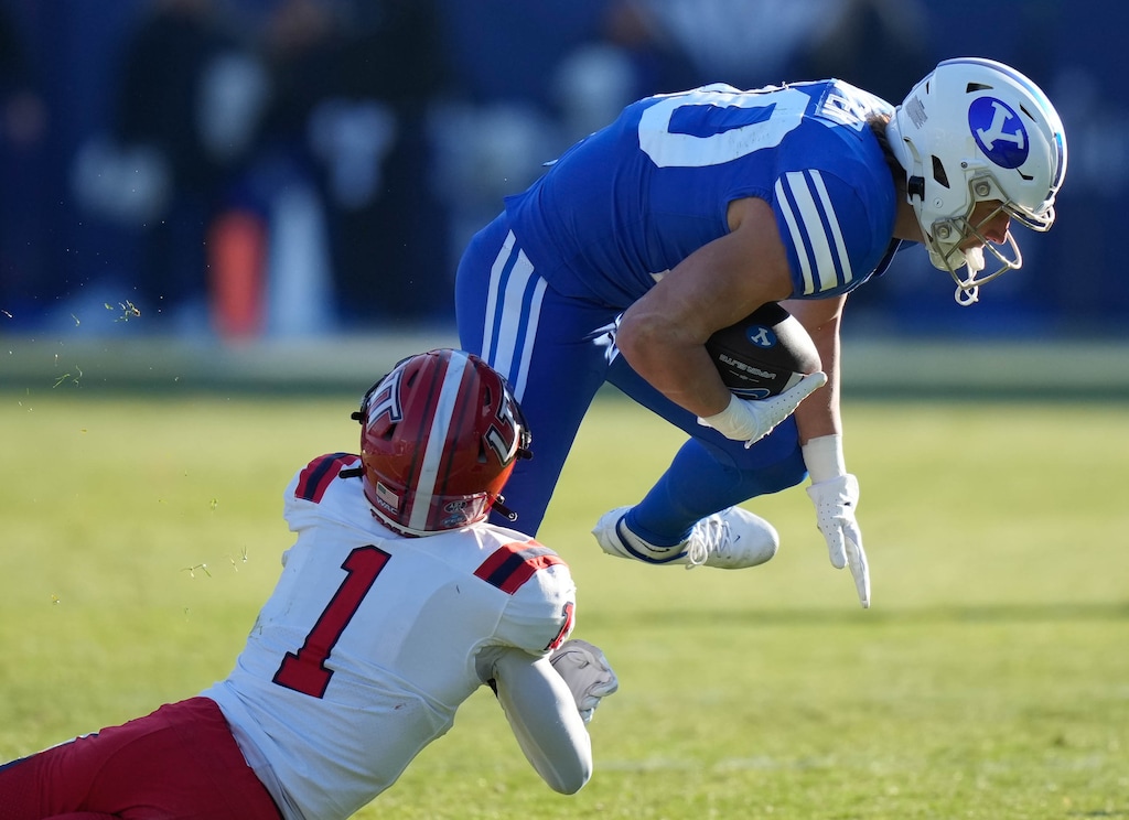 (Francisco Kjolseth | The Salt Lake Tribune) Utah Tech's Deven Osborne (1) takes down Brigham Young Cougars wide receiver Brayden Cosper (20) in football action between the Brigham Young Cougars and the Utah Tech Trailblazers at LaVell Edwards Stadium in Provo, Saturday, Nov. 19, 2022.