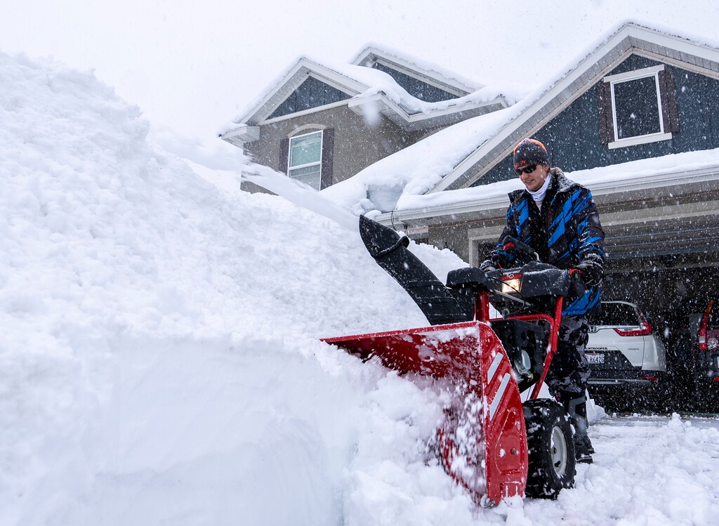 (Leah Hogsten | The Salt Lake Tribune) Austin Bingham operates a snow blower to clear his family's driveway in Mountain Green on Monday, April 3, 2023.
