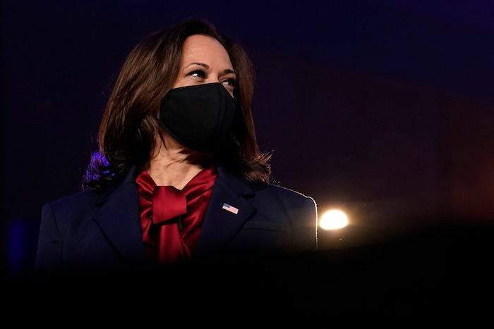 Democratic vice presidential candidate Sen. Kamala Harris, D-Calif., listens as Democratic presidential candidate former Vice President Joe Biden speaks Friday, Nov. 6, 2020, in Wilmington, Del. (AP Photo/Carolyn Kaster)