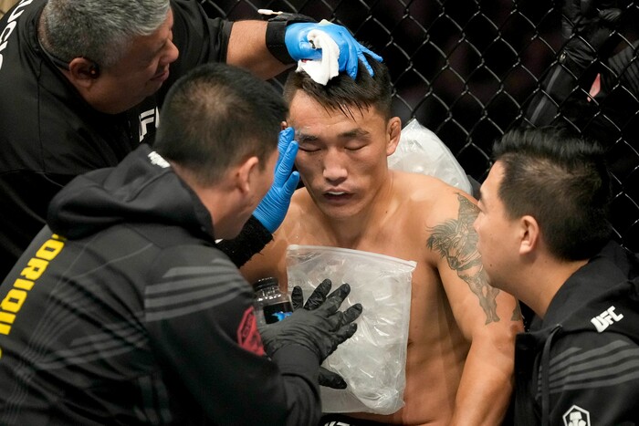(Francisco Kjolseth | The Salt Lake Tribune) Aoriqileng of China is attended between rounds during his fight with Jay Perrin of the United States in their bantamweight bout at Vivint Arena for UFC 278 on Saturday, Aug. 20, 2022. 