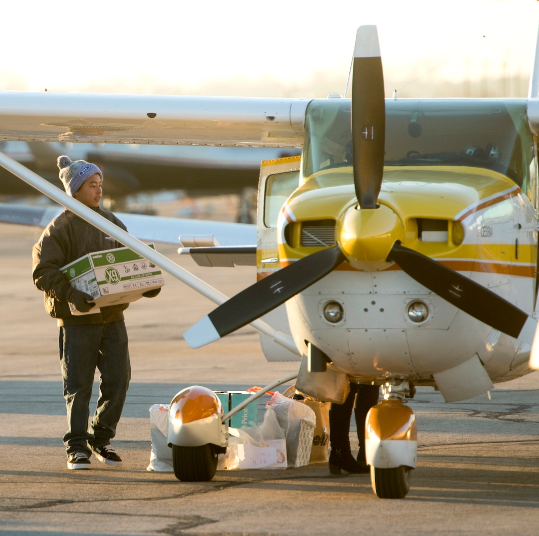 (Rick Egan  |  The Salt Lake Tribune) Gonzolo Perez, West Valley, loads donations on to a plane early in the morning in Salt Lake City for the flight to Centennial Elementary School, in Roosevelt, Utah. Perez helped gather items for the school as part of his eagle scout project. Volunteer pilots from the Utah Wing of Angel Flight West,  brought school supplies and gifts to students in Roosevelt on their annual Santa Flight. Friday, December 8, 2017.