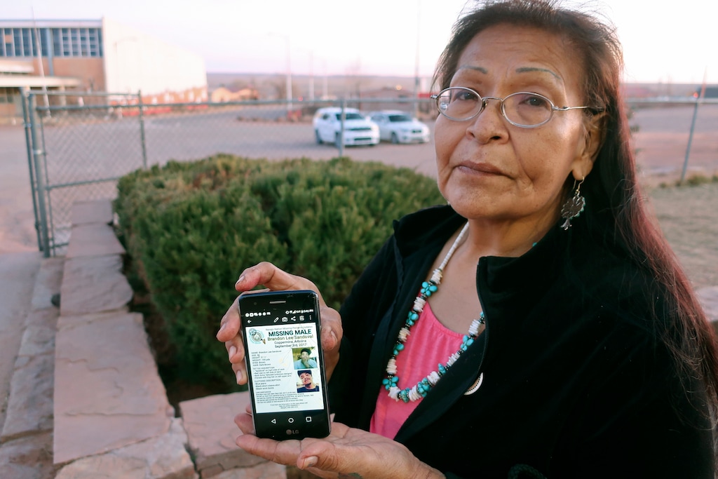 (Felicia Fonseca | AP file photo) Margaret Bitsue displays a flier that features her son who she reported missing more than two years ago, Tuba City, Ariz., on Jan. 14, 2020/ Bitsue hasn't seen or heard from Brandon Sandoval, the youngest of her four children, in more than two years. "I spend most of my days looking down the road expecting him to come up," Bitsue says.