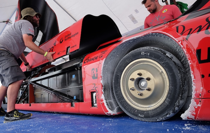 (Francisco Kjolseth  |  The Salt Lake Tribune)  The crew of the all wheel drive electric Venturi vehicle from Ohio State University pull the panels covering the batteries during Speed Week at the Bonneville Salt Flats outside Wendover on Monday, Aug. 14, 2017.