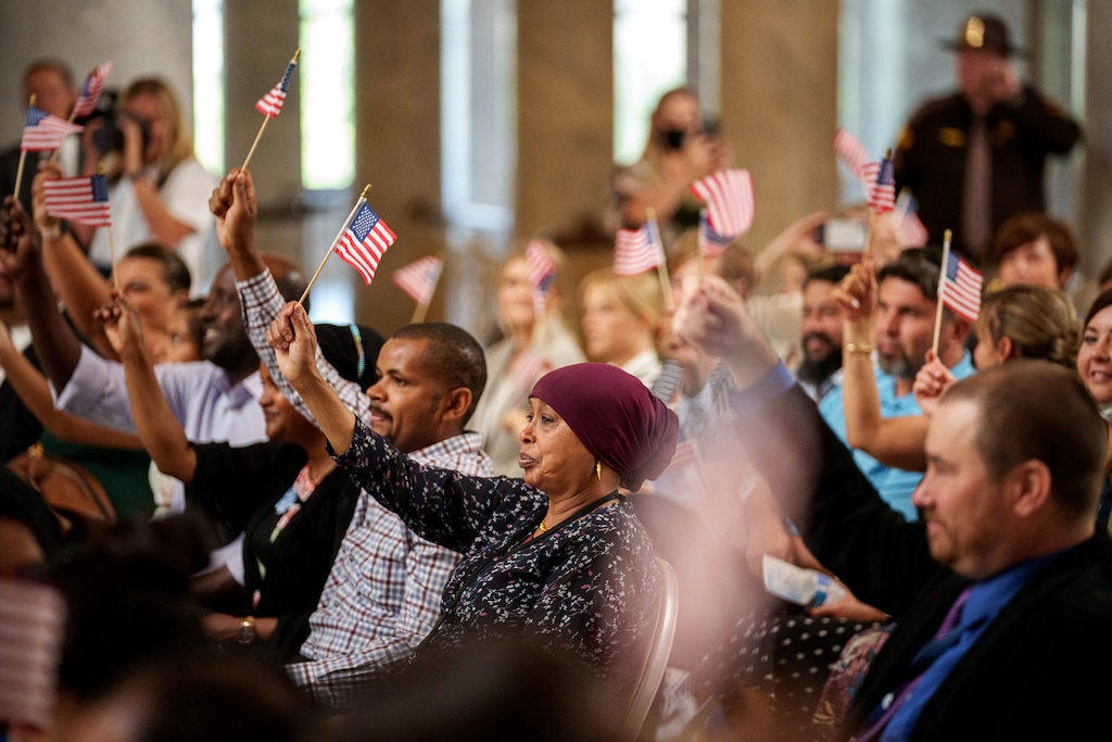 (Trent Nelson  |  The Salt Lake Tribune) Flags are waved to recognize fourteen new citizens at a naturalization ceremony that was part of Utah’s World Refugee Week celebration, in Salt Lake City on Tuesday, June 15, 2021.