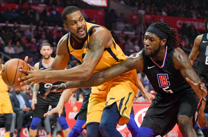 Los Angeles Clippers forward Montrezl Harrell, right, attempts to grab the ball from Utah Jazz forward Derrick Favors during the first half of an NBA basketball game in Los Angeles, Thursday, Nov. 30, 2017. (AP Photo/Kelvin Kuo)