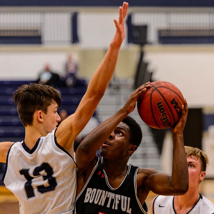 (Trent Nelson | The Salt Lake Tribune)  Bountiful's Jaxon Wood (5) shoots, with Corner Canyon's Hayden Welling (13) defending, as Corner Canyon faces Bountiful in the title game of the Corner Canyon Tournament of Champions, high school boys' basketball in Draper, Saturday December 2, 2017.