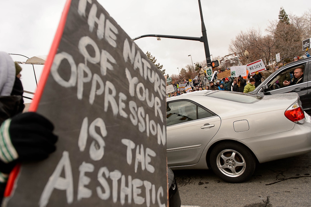 (Trent Nelson | The Salt Lake Tribune)  Protesters clash with motorists after blocking off an intersection after a rally against a visit by President Donald Trump, Monday December 4, 2017.