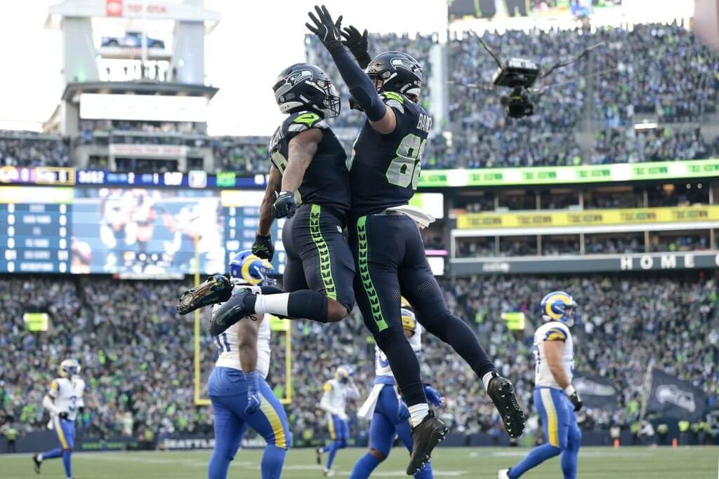 Seattle running back Kenneth Walker III, left, celebrates with AJ Barner after scoring a touchdown in the Seahawks' victory over the Los Angeles Rams in the NFC Championship Game on Sunday in Seattle.
(Getty Images via The Athletic)