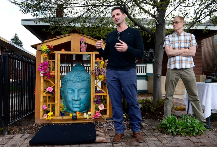 (Scott Sommerdorf | The Salt Lake Tribune)
Artist Eric Wilson, center, speaks about the process he used to restore the Buddha as Benjamin Dieterle stands at right, during a rededication ceremony and celebration, Sunday, April 8, 2018.