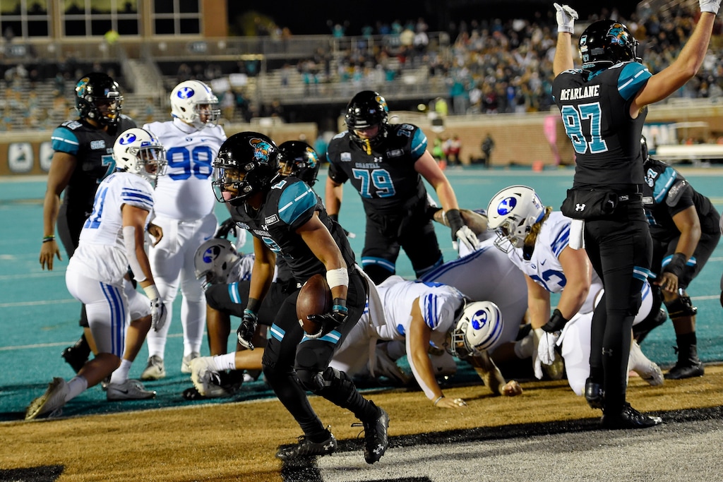 Coastal Carolina's Reese White, center, scores a touchdown during the first half of an NCAA college football game against BYU Saturday, Dec. 5, 2020, in Conway, S.C. (AP Photo/Richard Shiro)