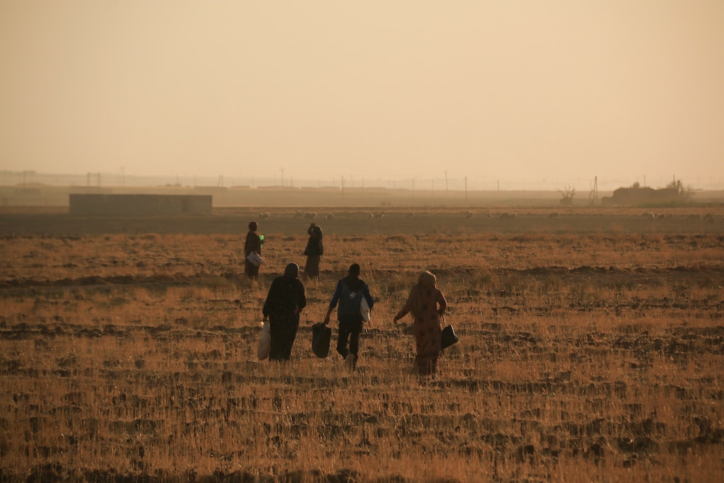 (Baderkhan Ahmad | AP) Syrians flee shelling by Turkish forces in Ras al Ayn, northeast Syria, Wednesday, Oct. 9, 2019. Turkish President Recep Tayyip Erdogan announced Wednesday the start of a Turkish military operation against Kurdish fighters in northeastern Syria.