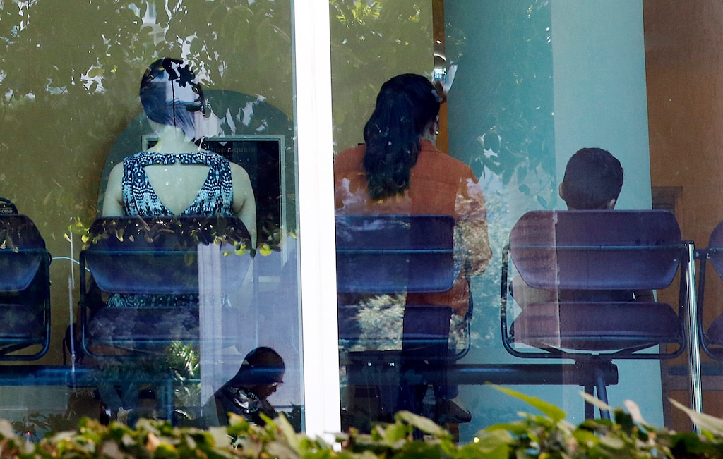 In this June 12, 2019, photo, immigrants wait inside and outside of the immigration court in Miami. The Trump administration has appointed more than 4 in 10 of the country’s sitting immigration judges in a hiring surge that comes as U.S. authorities seek to crack down on immigration. (AP Photo/Brynn Anderson)