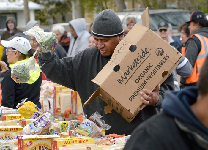 (Al Hartmann | The Salt Lake Tribune)
Volunteer Sala Asiata of the Utah Food Bank helps pack food boxes in the parking lot of the LDS Church at 1860 S. 300 E. in Salt Lake City Friday April 13. It's one of 18 locations the bank operates to get food out to the food insecure. An army of volunteers make the distrbution system work. Walmart, Feeding America and Utah Food Bank are teaming up during the month of April to fight hunger through an online and in-store donation campaign.