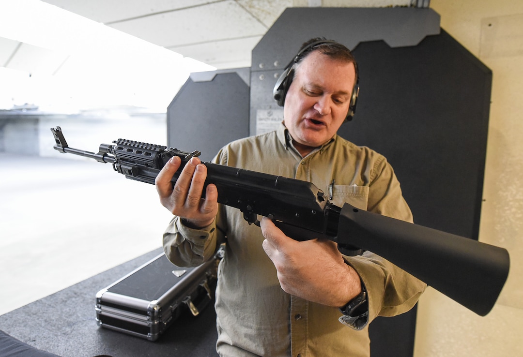 (Francisco Kjolseth  |  The Salt Lake Tribune)  Utah gun rights advocate Clark Aposhian, one of only a handful of Americans who are legally allowed to keep their bump stock, a shooting accessory that alters semi-automatic rifles to fire in quick bursts like a machine gun, demonstrates how it works on an AKM-47 at a gun range in Murray, UT, on Thursday, April 4, 2019. He is challenging the bump stock ban in court, and an appeals court has allowed him to keep his bump stock until his case is resolved in court.